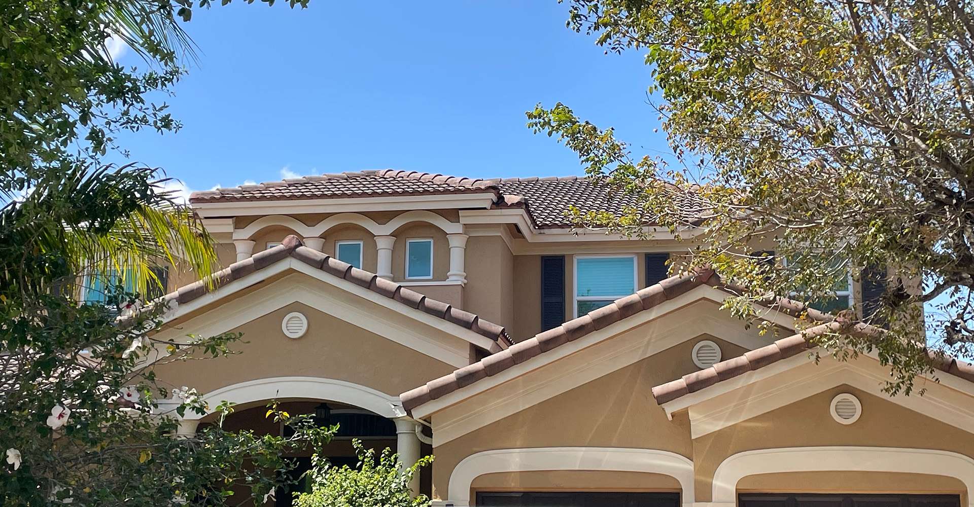 Freshly soft-washed Miami home with a clean tile roof