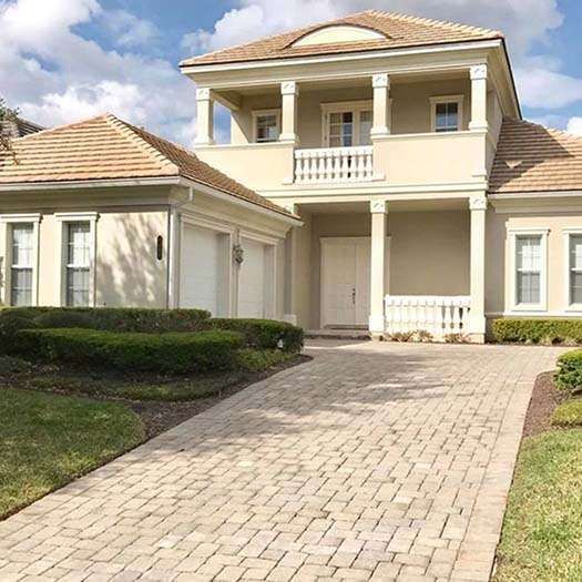 Clean clay tile roof and brick driveway after soft washing